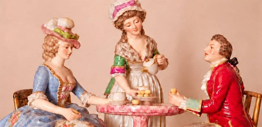 Grupo de porcelana: dos damas y un caballero tomando el té